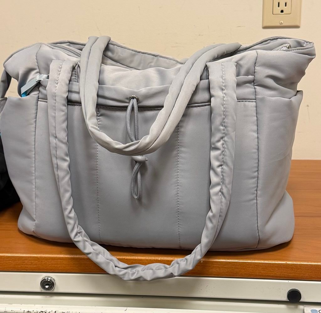 Light grey work tote bag with padding, multiple pockets, and a roomy structured design.