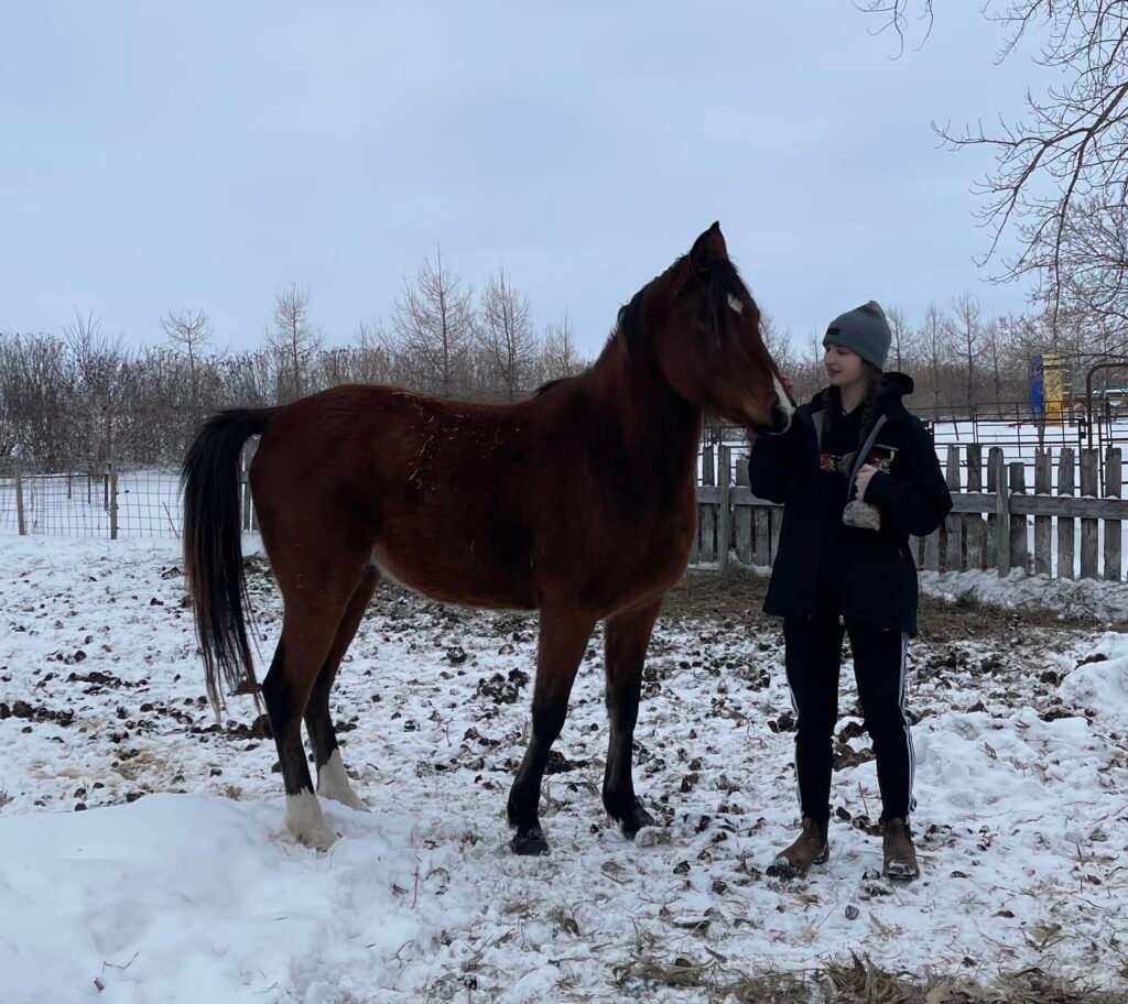 Apollo standing in the snow with Jaydyn when we first went to see him.